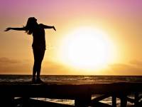 woman celebrating the sun rising, vitamin d natural